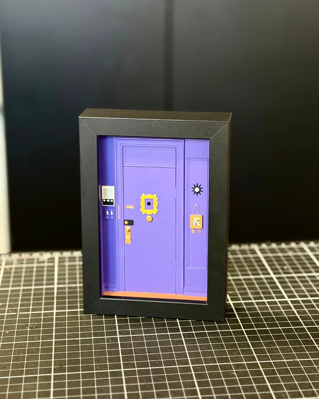 Framed miniature of the purple apartment door with the yellow peephole frame from Friends