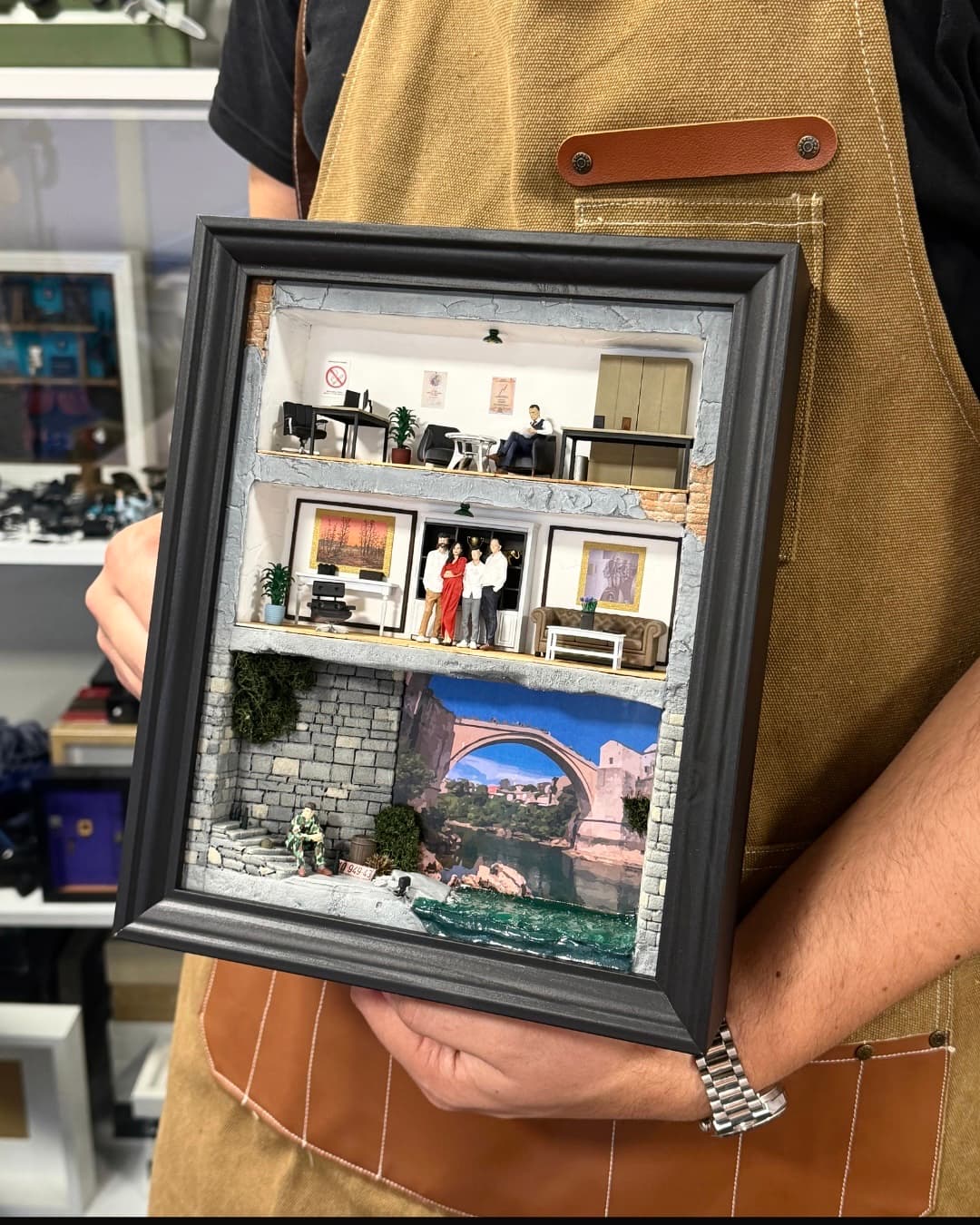 Framed three-level miniature with an office, a family living room and the Old Bridge in Mostar