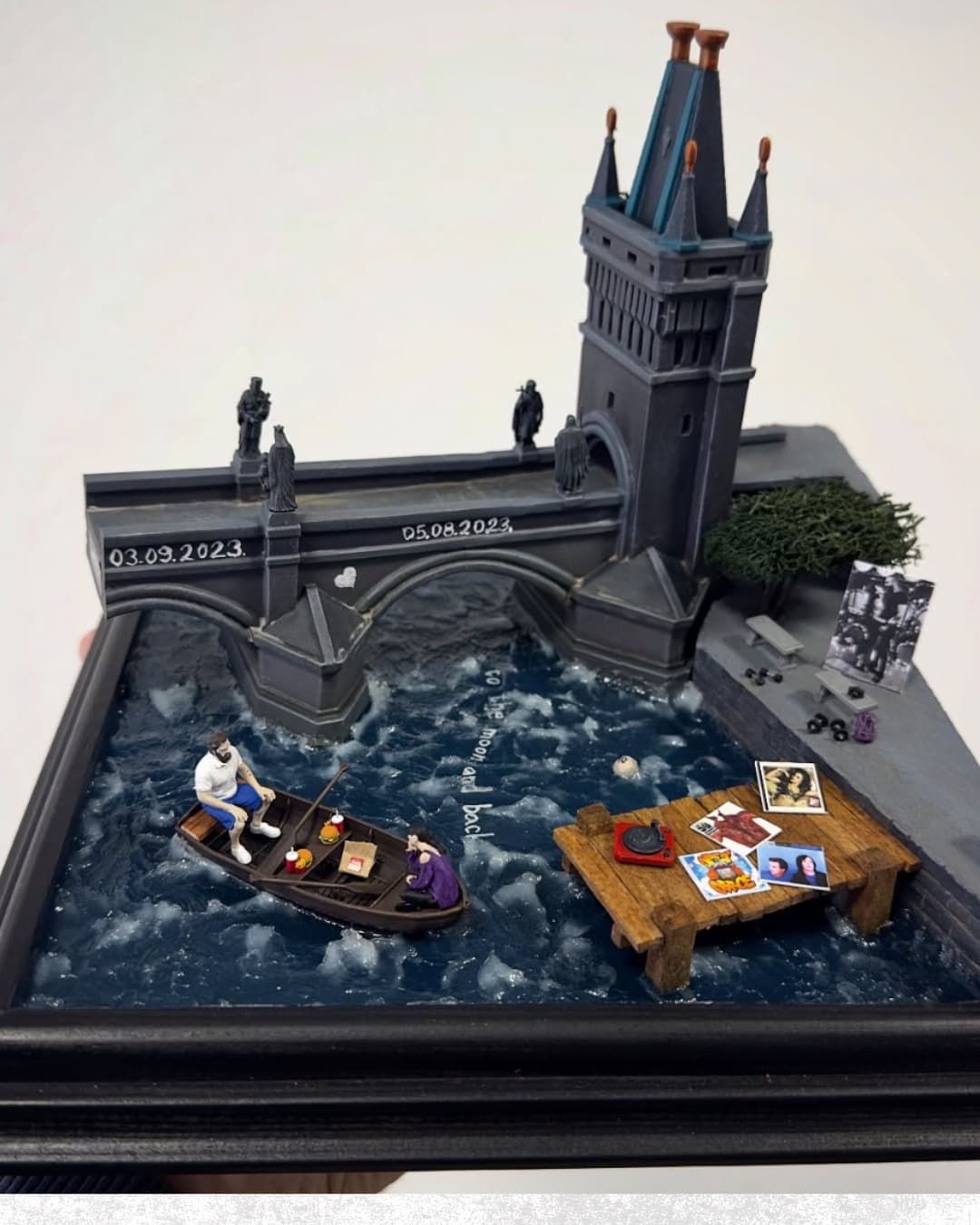 Diorama of Charles Bridge in Prague with a couple in a rowing boat on the river