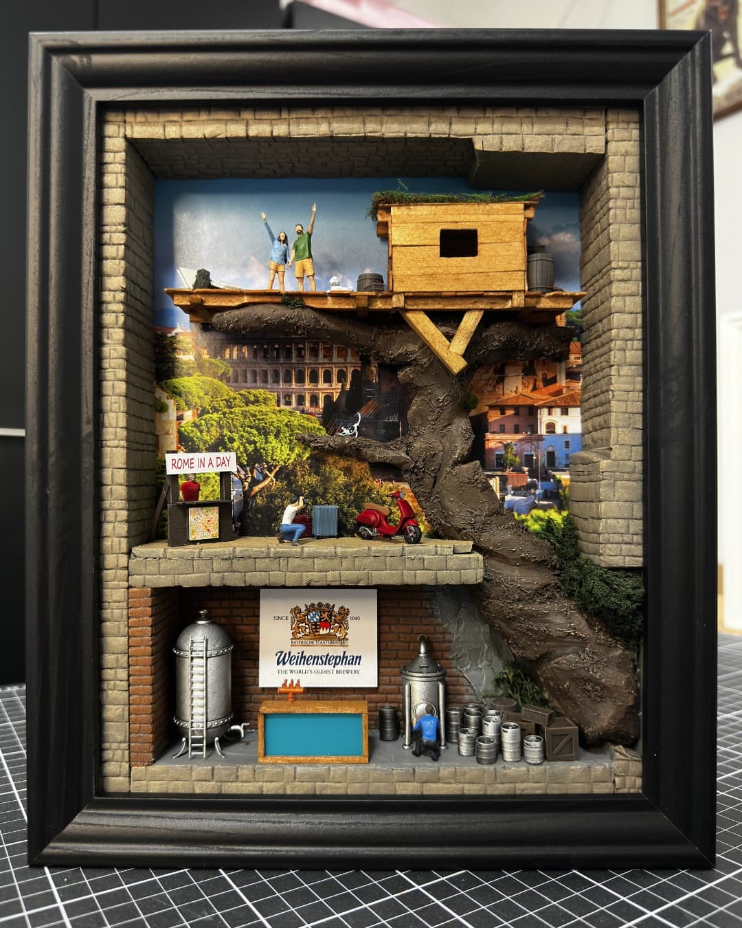 Framed miniature of a treehouse above Rome with the Colosseum, a red scooter and a small brewery